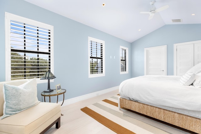 bedroom featuring visible vents, wood finished floors, baseboards, ceiling fan, and vaulted ceiling