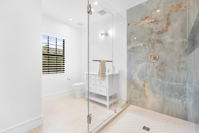 full bath with visible vents, toilet, a marble finish shower, baseboards, and vanity