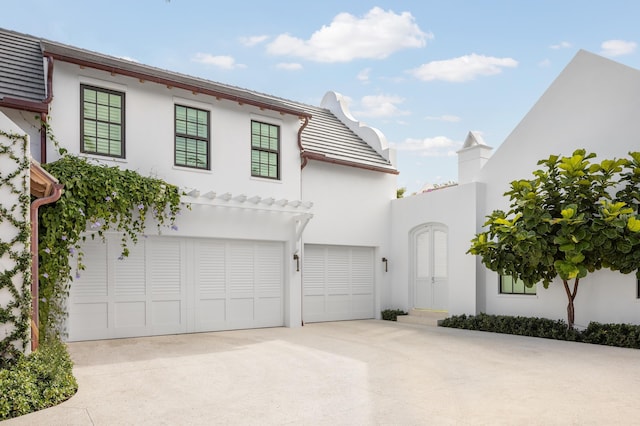 view of front of house featuring concrete driveway and stucco siding