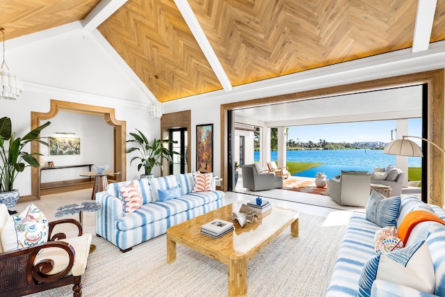 living room with a water view, high vaulted ceiling, and a chandelier