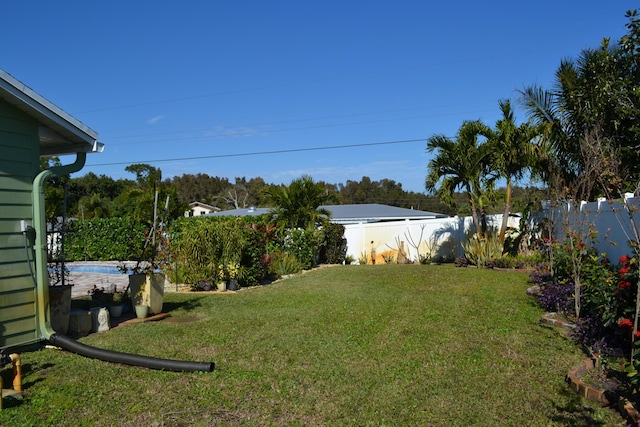 view of yard with a fenced in pool