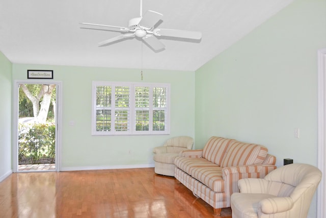 living area with ceiling fan and light hardwood / wood-style flooring