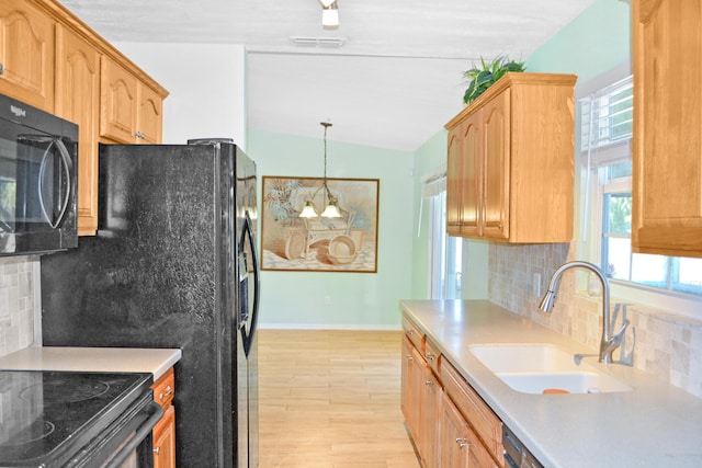 kitchen with light hardwood / wood-style floors, decorative backsplash, lofted ceiling, hanging light fixtures, and sink