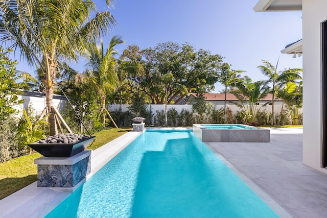 view of swimming pool with an in ground hot tub