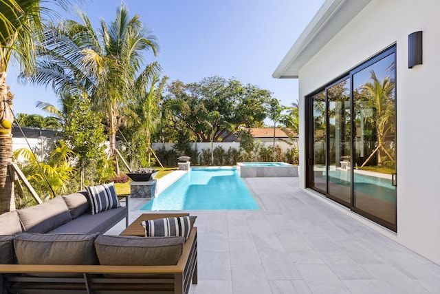 view of pool featuring an in ground hot tub, an outdoor living space, and a patio