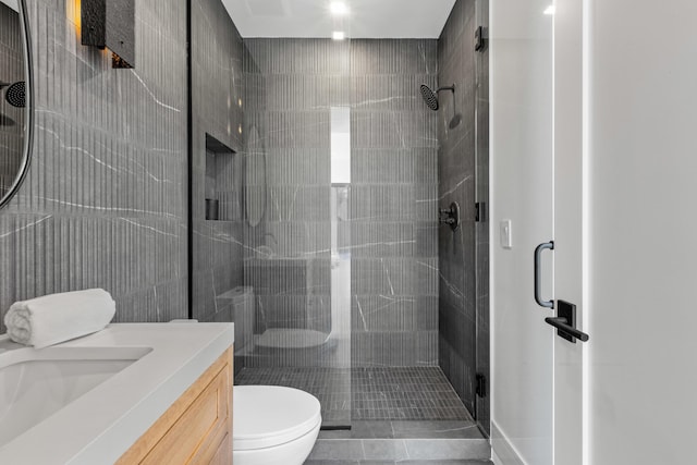 bathroom with vanity, tile patterned flooring, a shower with shower door, and toilet