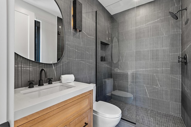 bathroom with toilet, a shower, tile walls, backsplash, and vanity