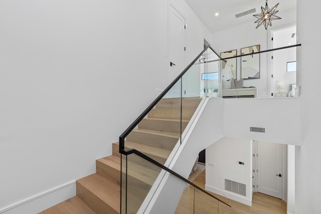 stairs featuring hardwood / wood-style floors