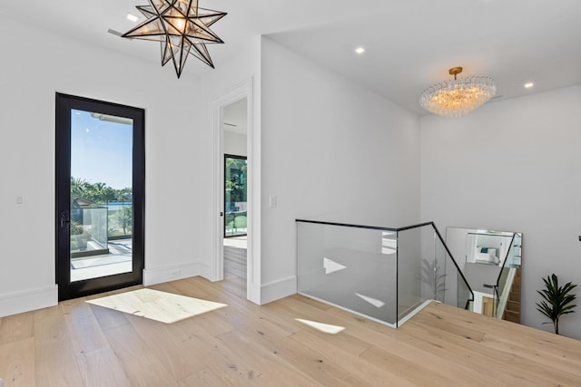 entryway featuring a chandelier and light wood-type flooring