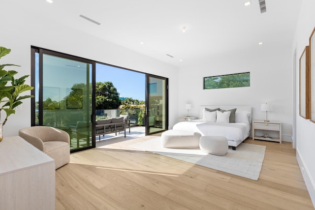 bedroom with access to outside and light wood-type flooring