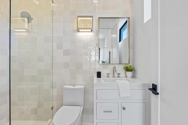 bathroom featuring tile walls, walk in shower, vanity, and toilet