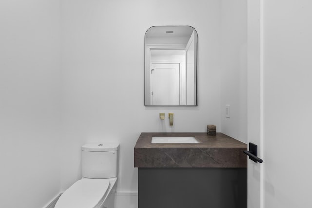 bathroom with toilet and vanity