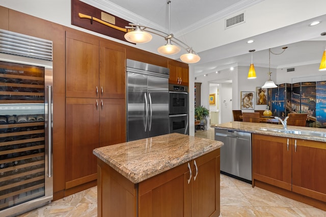 kitchen featuring stainless steel appliances, a center island, hanging light fixtures, crown molding, and wine cooler