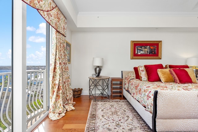 bedroom featuring hardwood / wood-style floors, access to outside, and crown molding