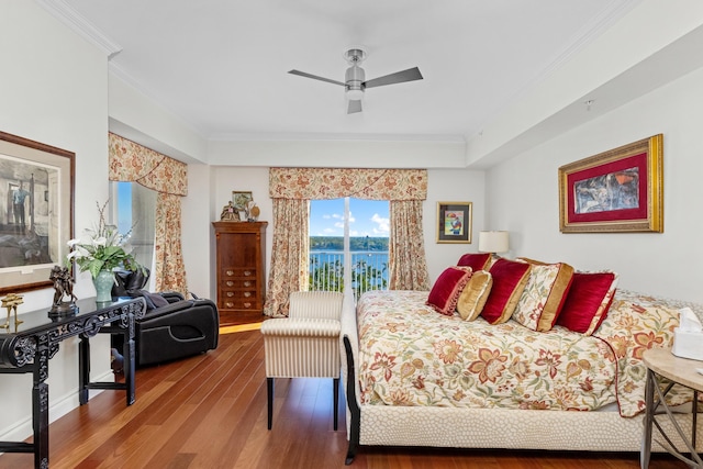 bedroom featuring wood-type flooring, ceiling fan, ornamental molding, and a water view