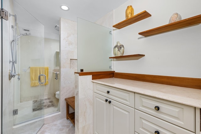 bathroom with toilet, an enclosed shower, and vanity