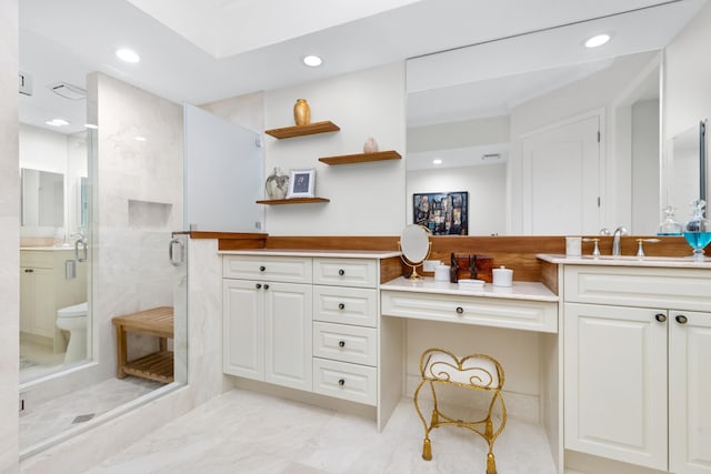 bathroom with toilet, a shower with door, and vanity