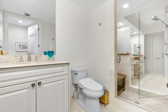 bathroom with vanity, a shower with shower door, and toilet