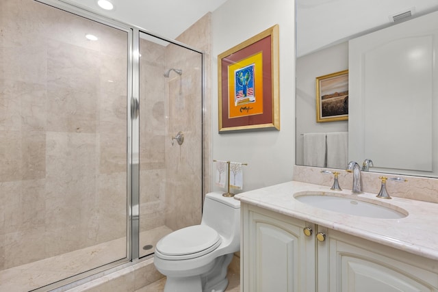 bathroom with toilet, a shower with door, and vanity