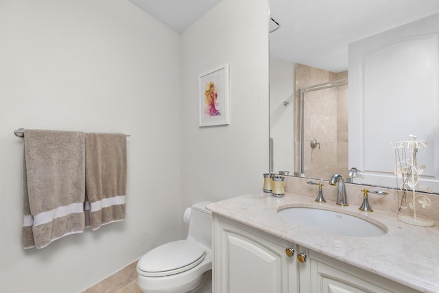 bathroom featuring toilet, an enclosed shower, vanity, and tile patterned floors