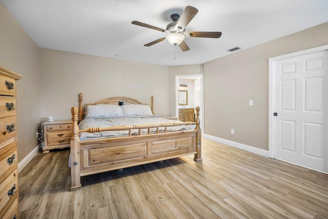 bedroom featuring a textured ceiling, ceiling fan, and hardwood / wood-style flooring