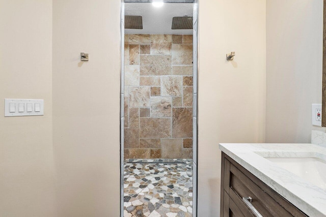 bathroom featuring a shower and vanity