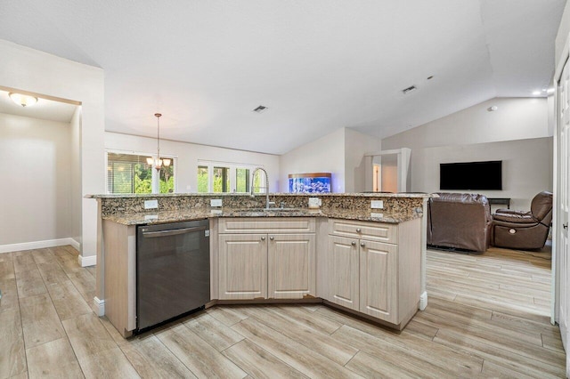 kitchen with sink, decorative light fixtures, vaulted ceiling, black dishwasher, and a kitchen island with sink