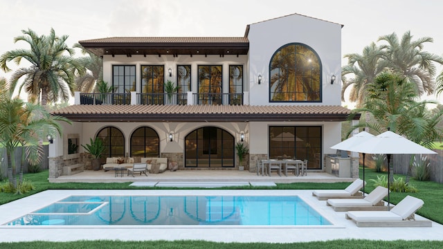 rear view of property featuring exterior kitchen, a balcony, and a patio area