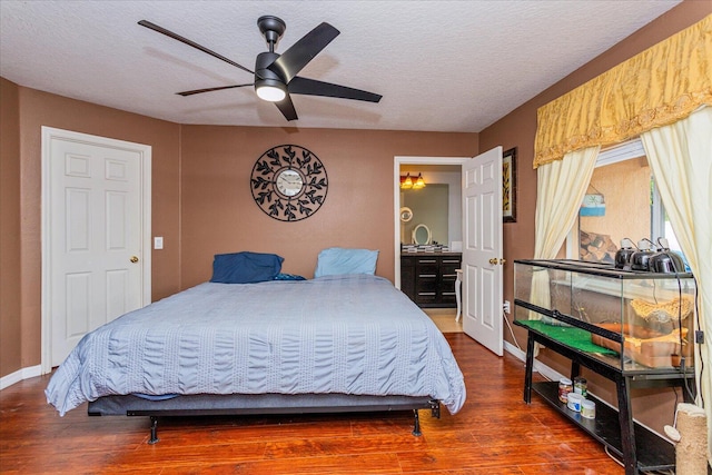 bedroom featuring a textured ceiling, ceiling fan, and dark hardwood / wood-style floors