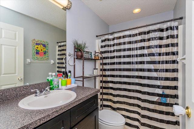 bathroom featuring a textured ceiling, a shower with shower curtain, vanity, and toilet