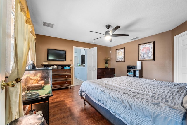 bedroom with a ceiling fan, visible vents, and dark wood-type flooring