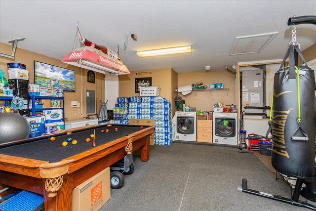 recreation room featuring electric panel, independent washer and dryer, and a textured ceiling