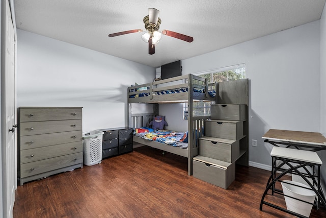 bedroom with a textured ceiling, wood finished floors, a ceiling fan, and baseboards