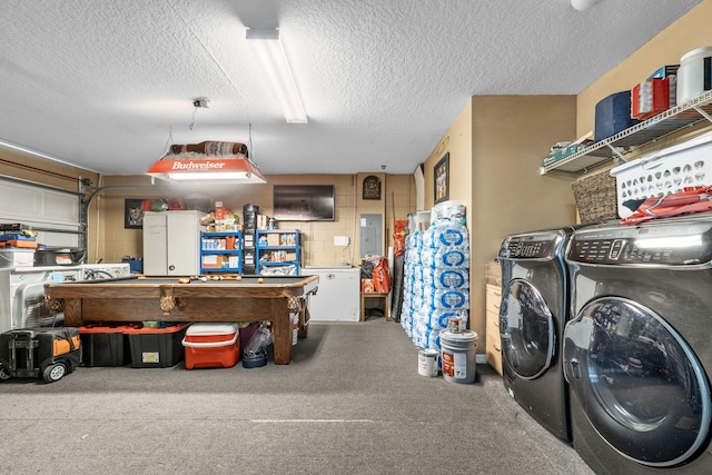 garage with electric panel and washer and clothes dryer