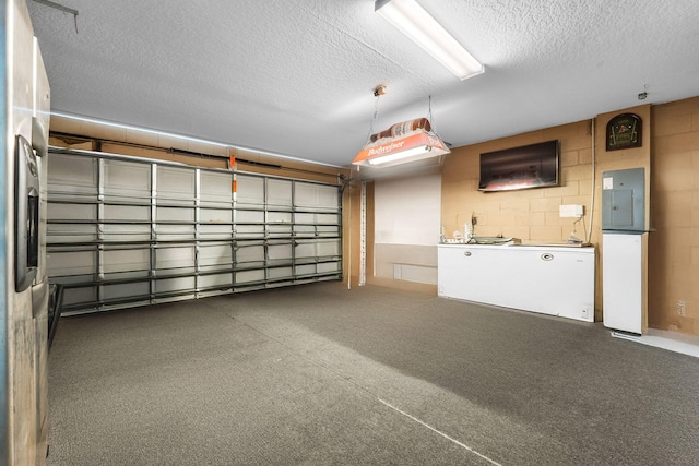 garage with concrete block wall and electric panel