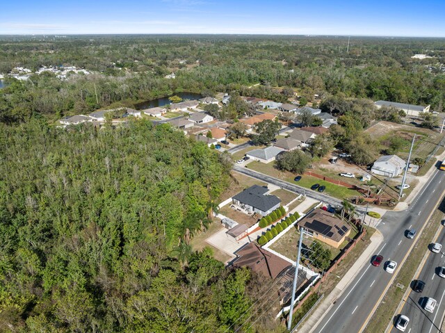 drone / aerial view with a wooded view