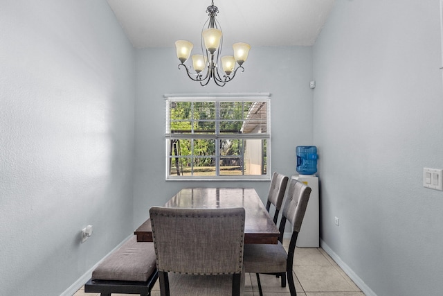 dining space featuring tile patterned floors, baseboards, and an inviting chandelier