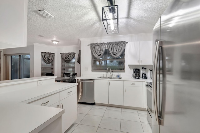 kitchen with sink, stainless steel appliances, and white cabinetry