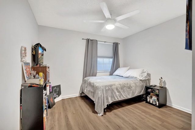 bedroom with ceiling fan and hardwood / wood-style flooring