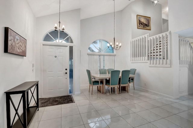 tiled foyer entrance with high vaulted ceiling and a notable chandelier