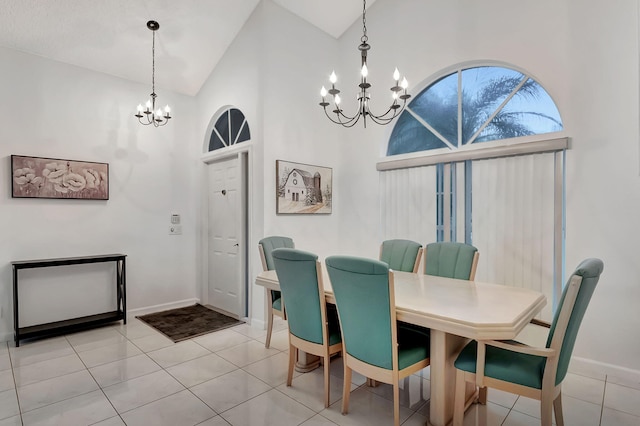 tiled dining area with high vaulted ceiling and an inviting chandelier