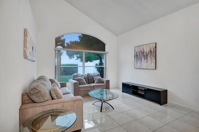 living room with light tile patterned floors and vaulted ceiling