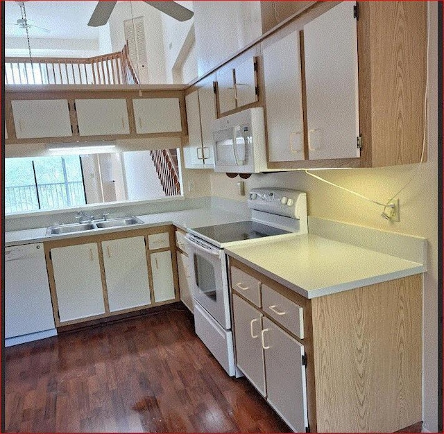 kitchen with white appliances, dark hardwood / wood-style flooring, and sink