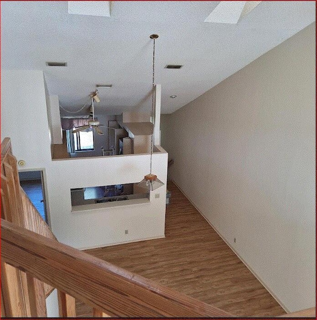 interior space featuring a textured ceiling and a skylight