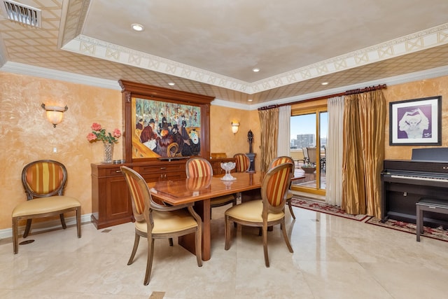 dining room featuring a raised ceiling and ornamental molding