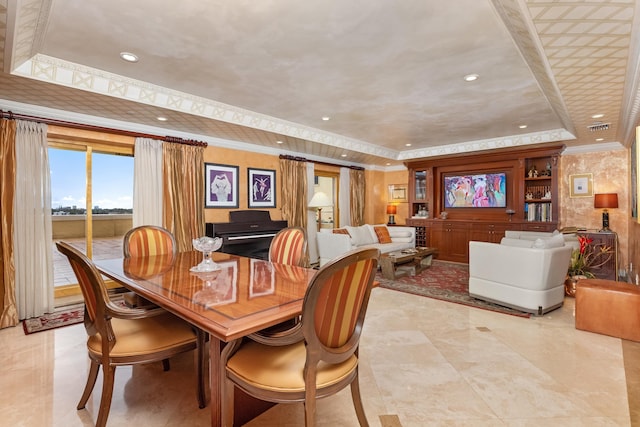 dining room with a raised ceiling and crown molding