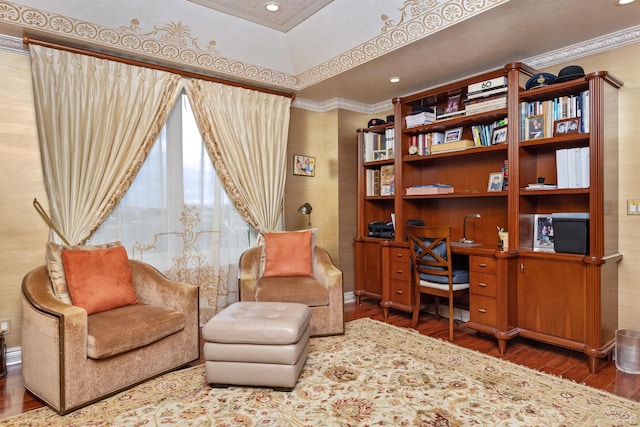 sitting room with ornamental molding and hardwood / wood-style floors