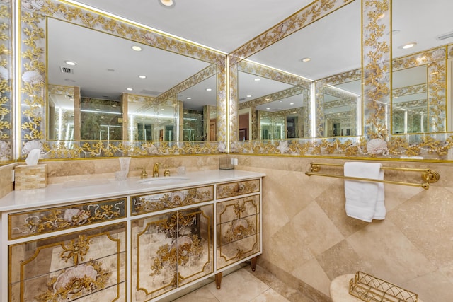 bathroom featuring tile patterned flooring, vanity, and tile walls