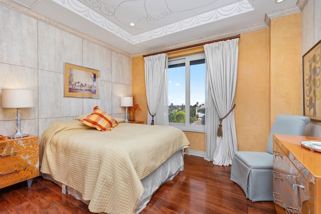 bedroom featuring crown molding and dark hardwood / wood-style floors