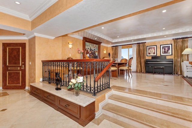 stairs featuring ornamental molding and a tray ceiling